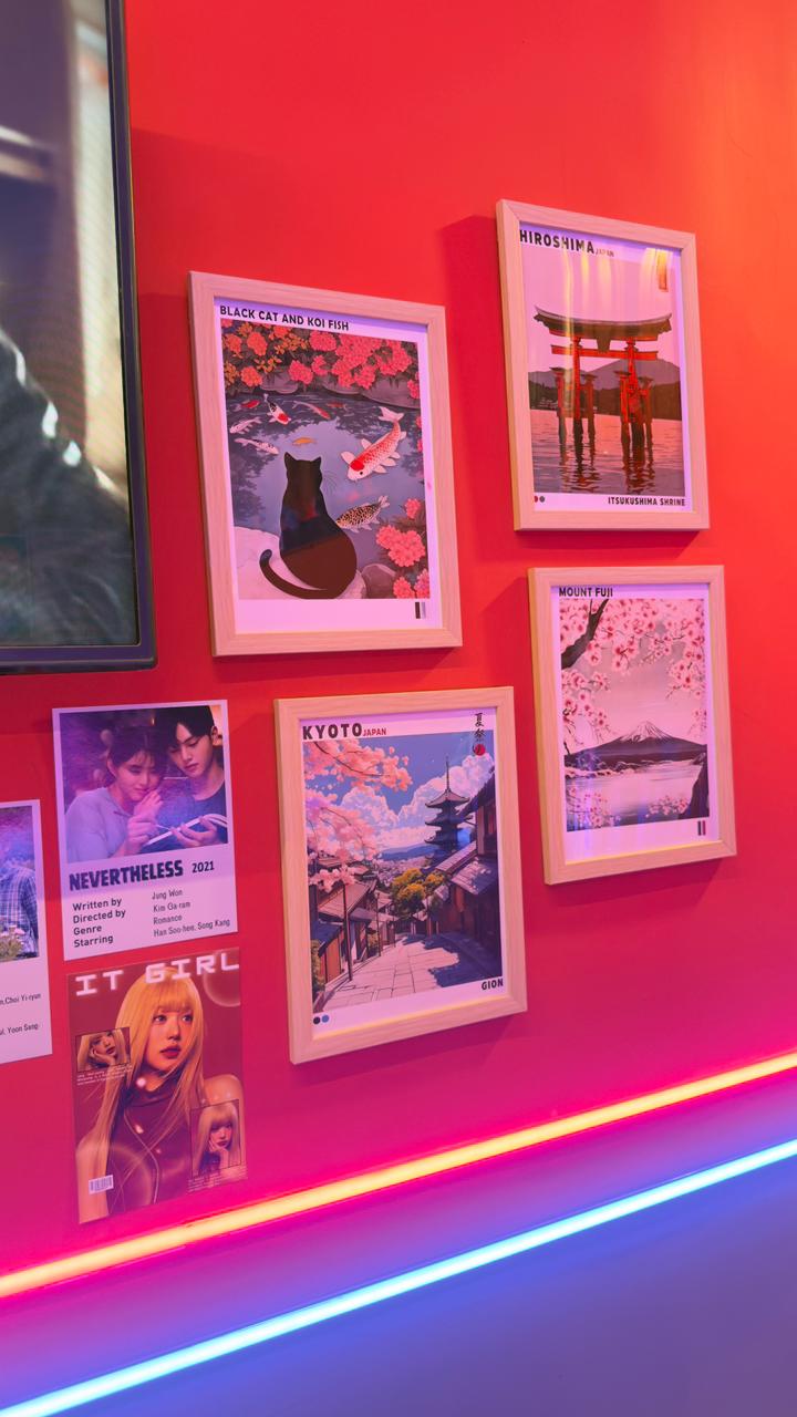Japan-themed art prints under warm pink and blue neon lighting