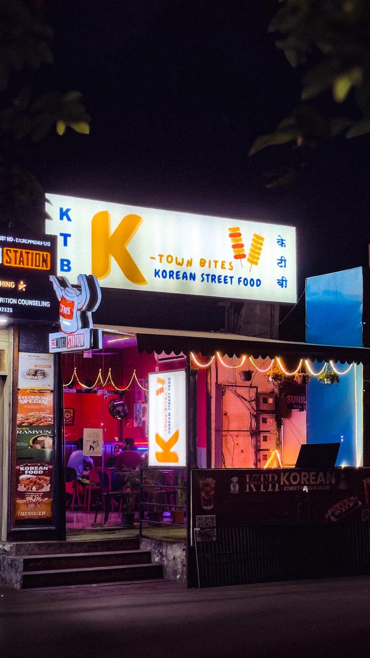 K-Town Bites Korean street food storefront at night with glowing neon signage in Kothrud, Pune